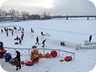 Children tubing and skating on the frozen Yshim River
